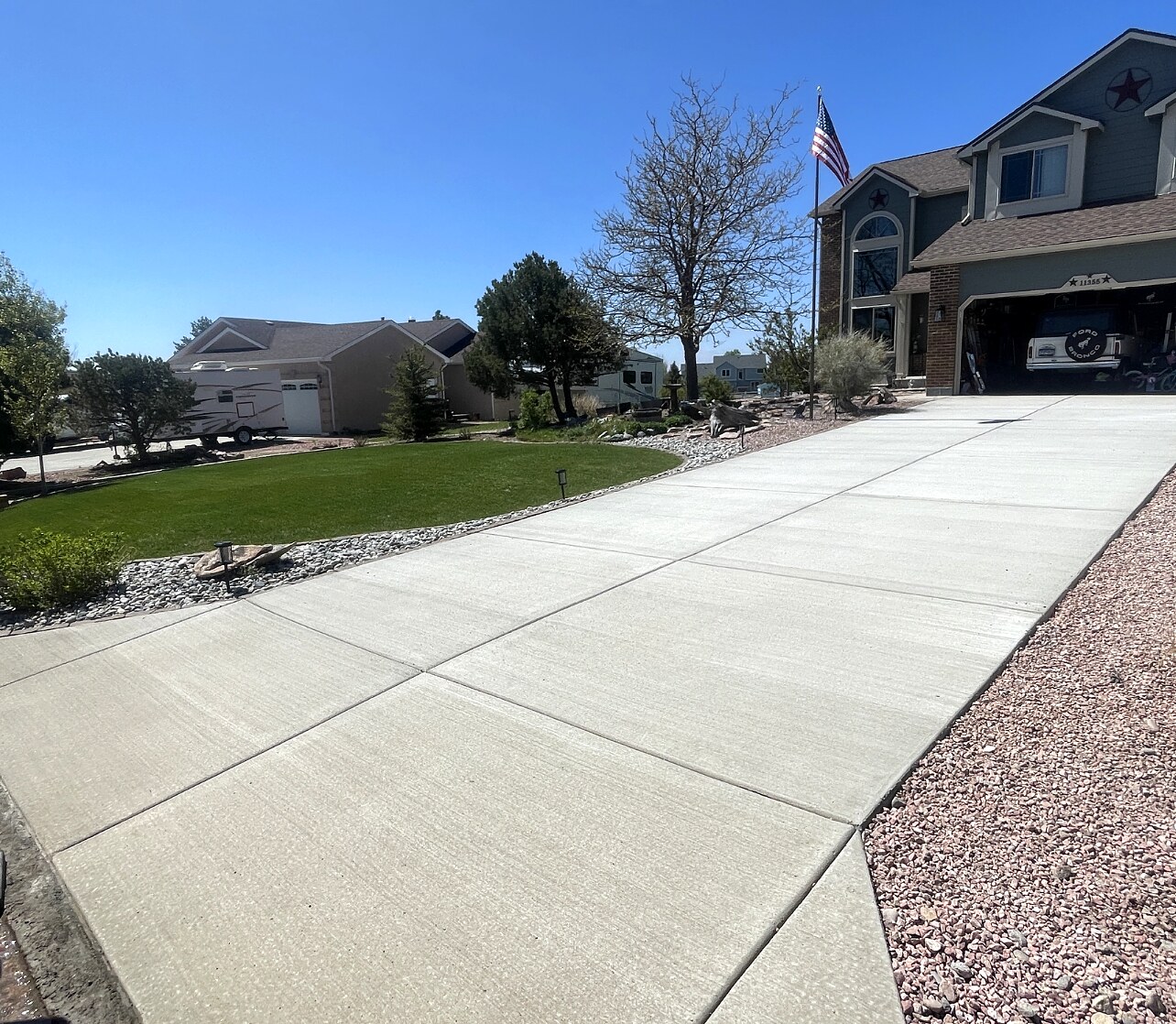 Angled view of an expansive new concrete driveway in Colorado Springs.