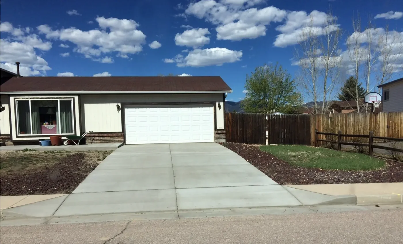Concrete driveway extension and widening alongside a Colorado home