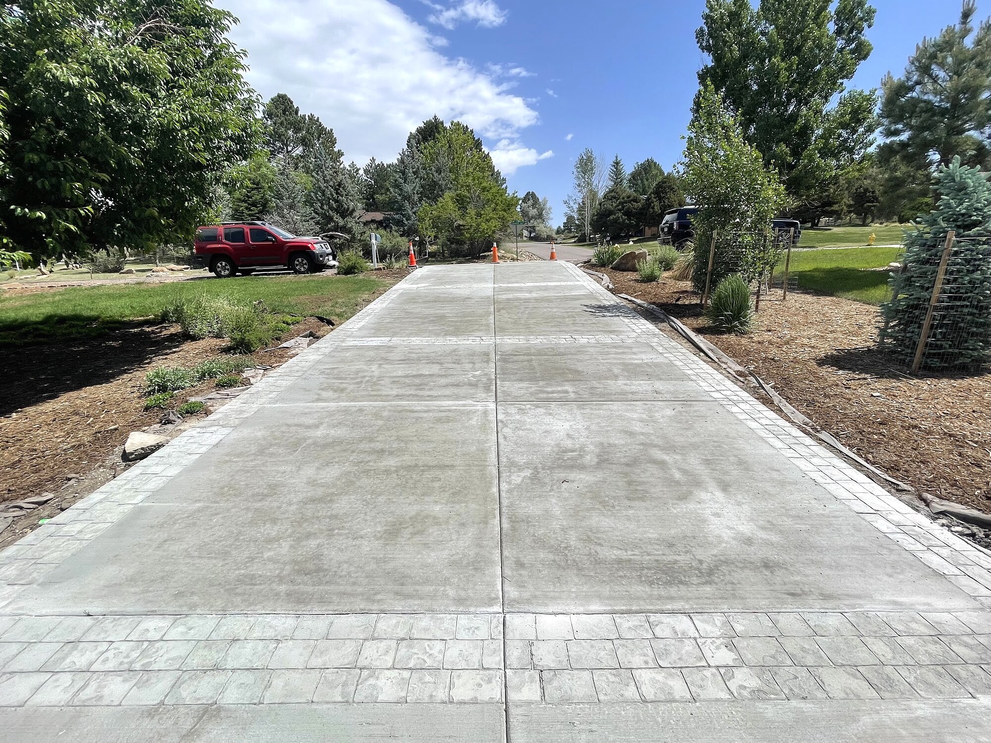 Long concrete driveway with textured decorative bands in Colorado Springs.