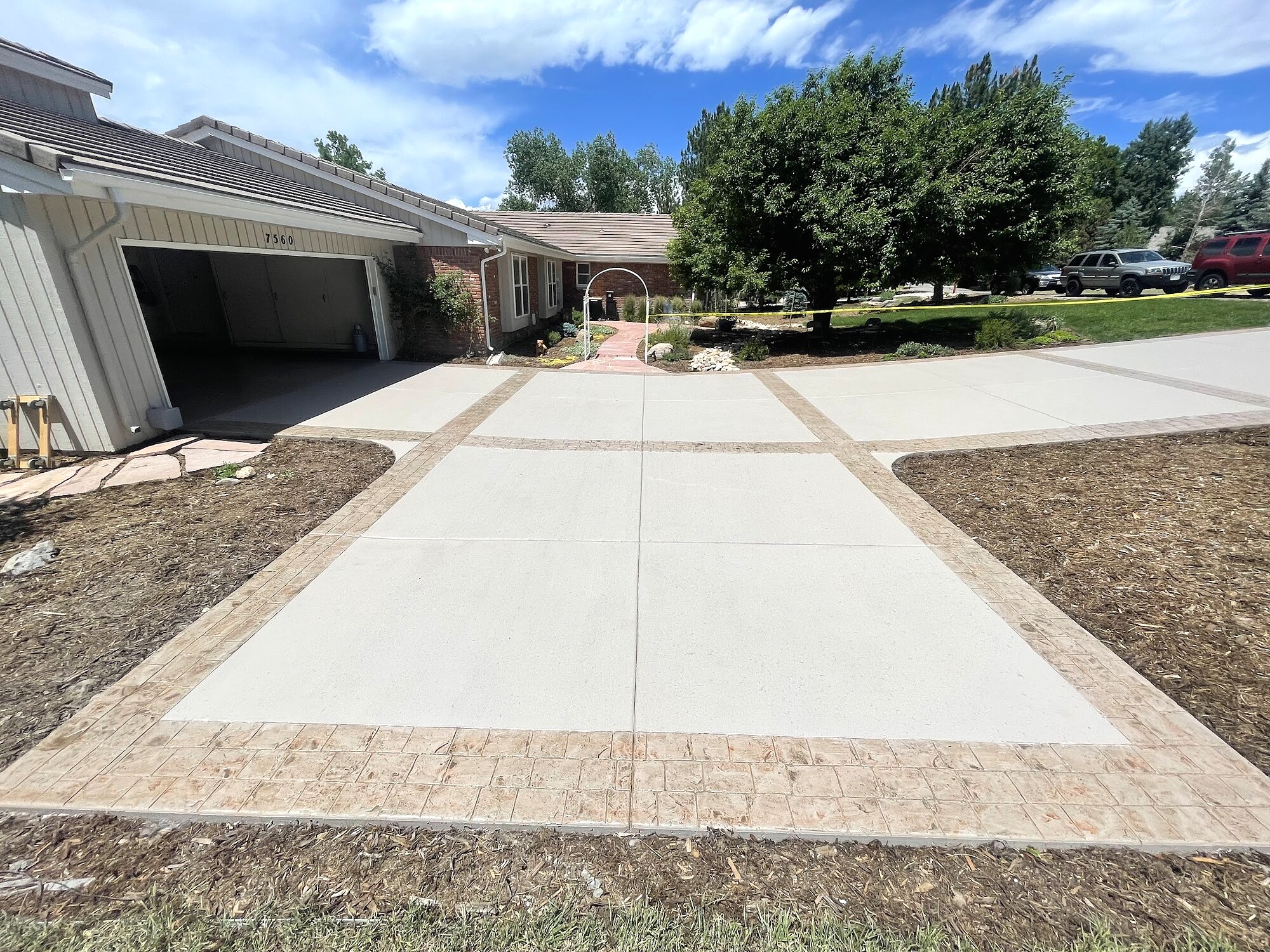 Wide concrete driveway with a decorative paver grid in Colorado Springs.
