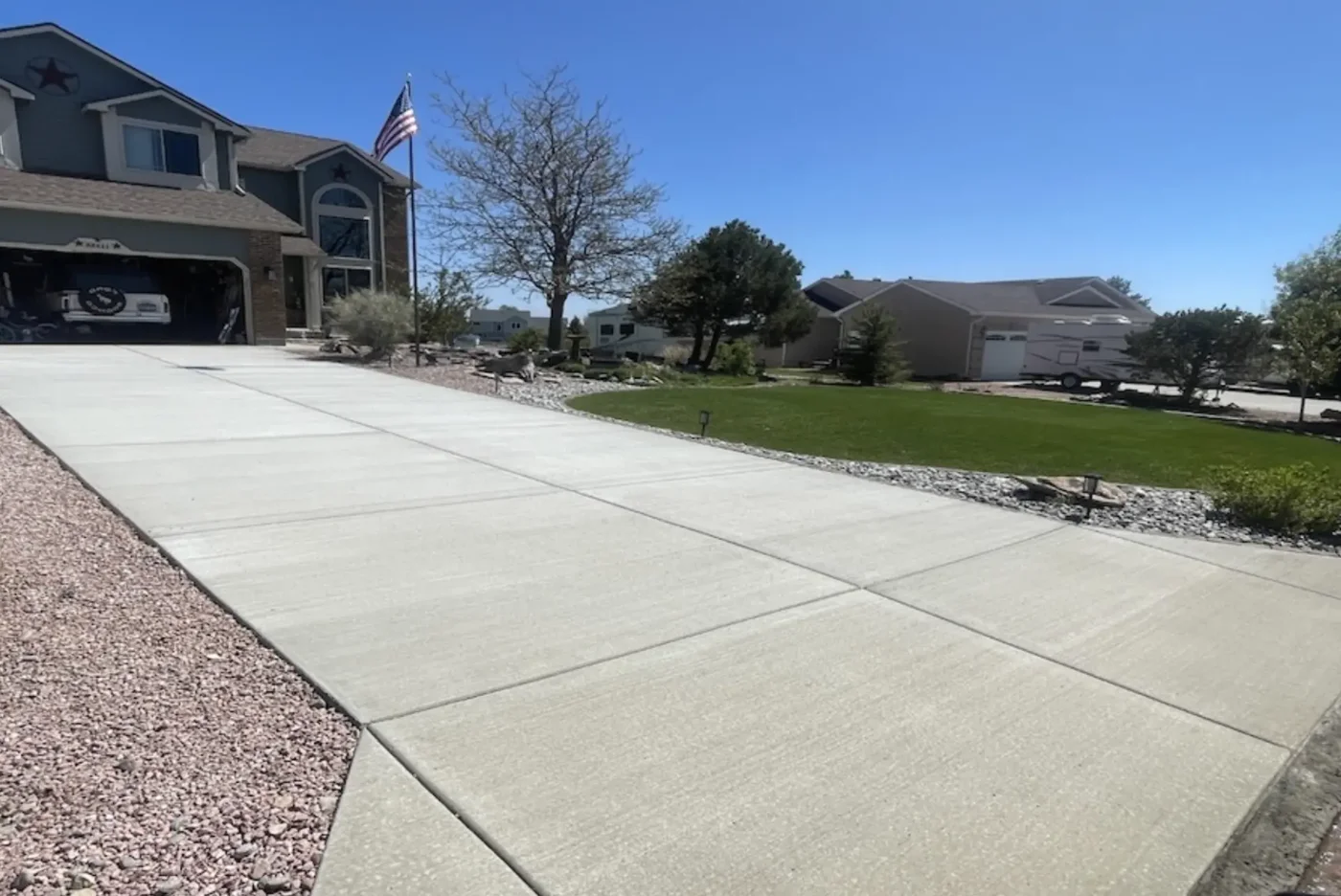 New concrete driveway installation leading to a Colorado home