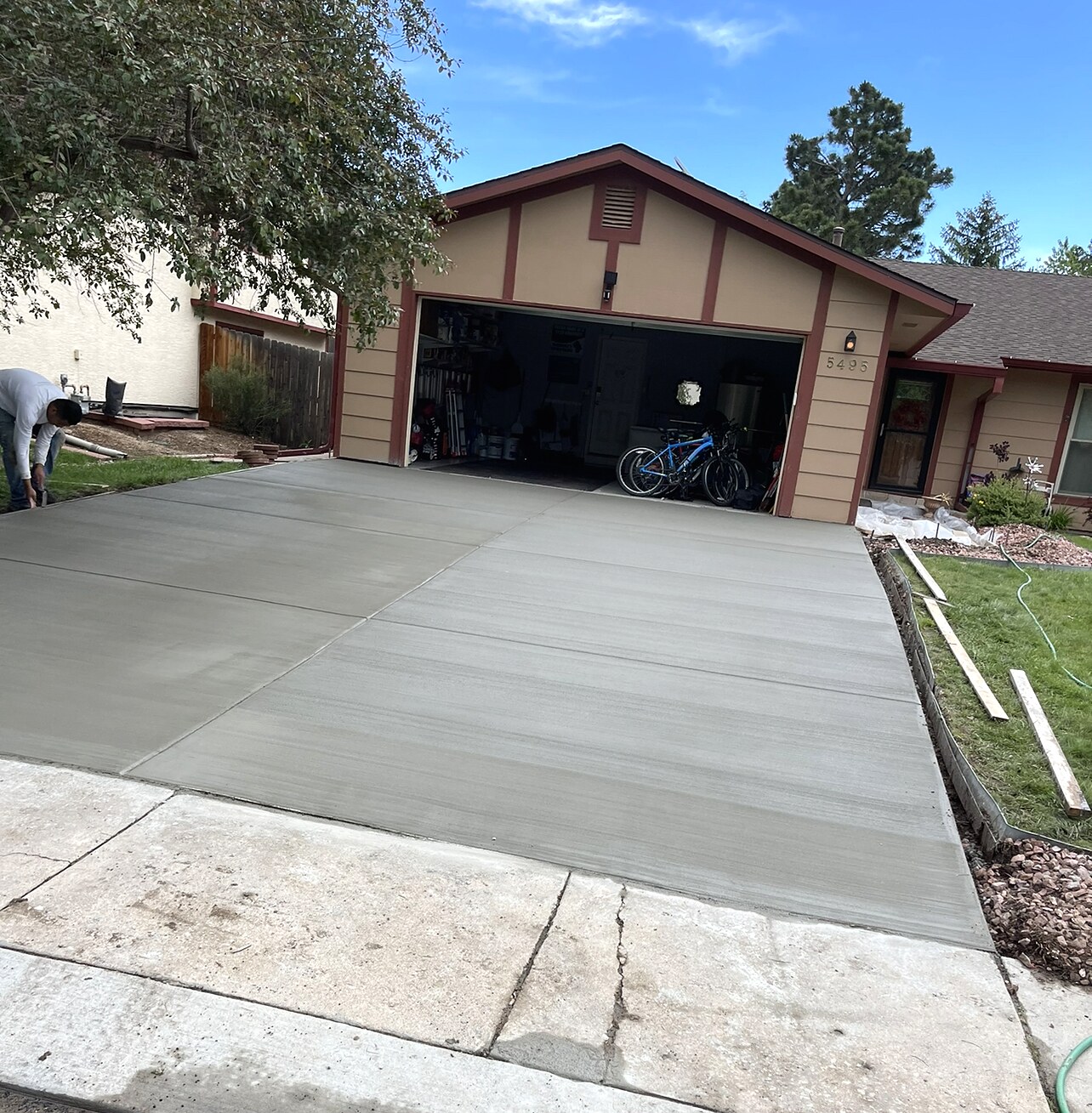 Fresh smooth concrete driveway at a Colorado Springs residential garage.