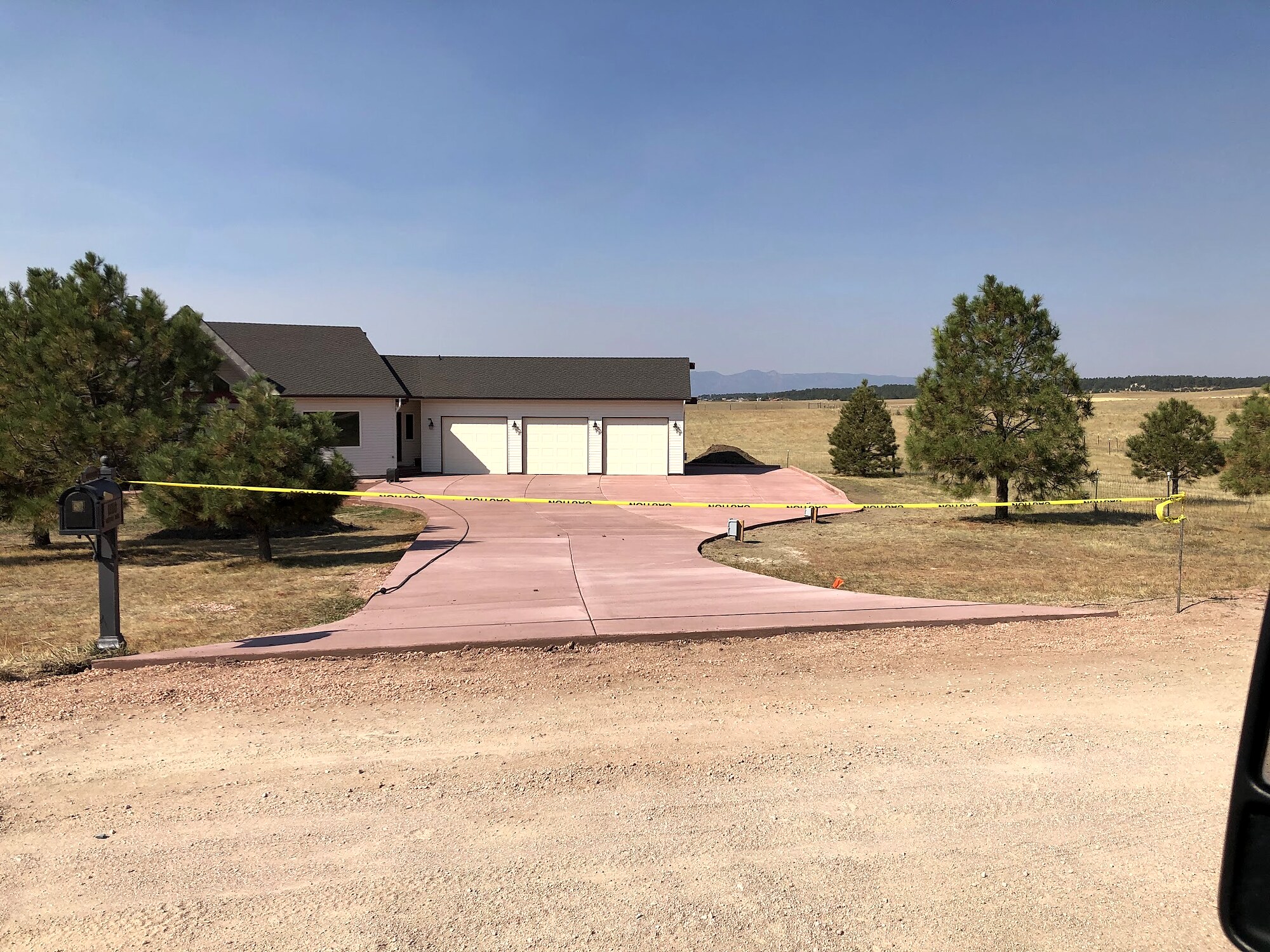 Large colored concrete driveway at a rural property near Colorado Springs.