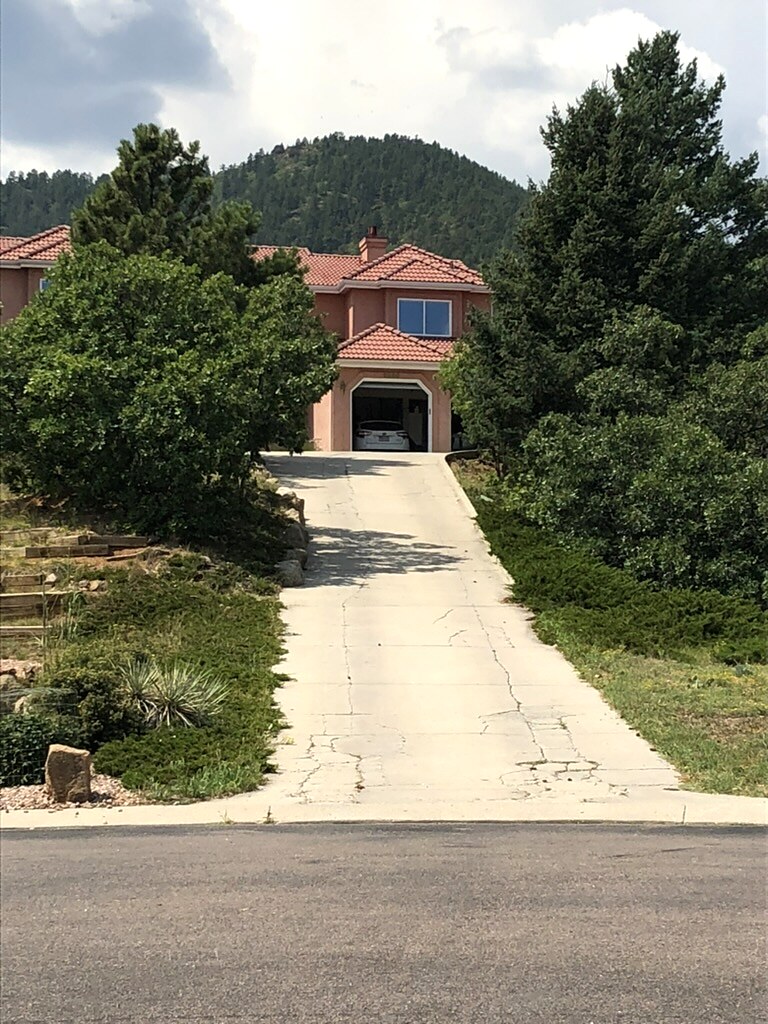 Steep concrete driveway leading to a mountain home near Colorado Springs.