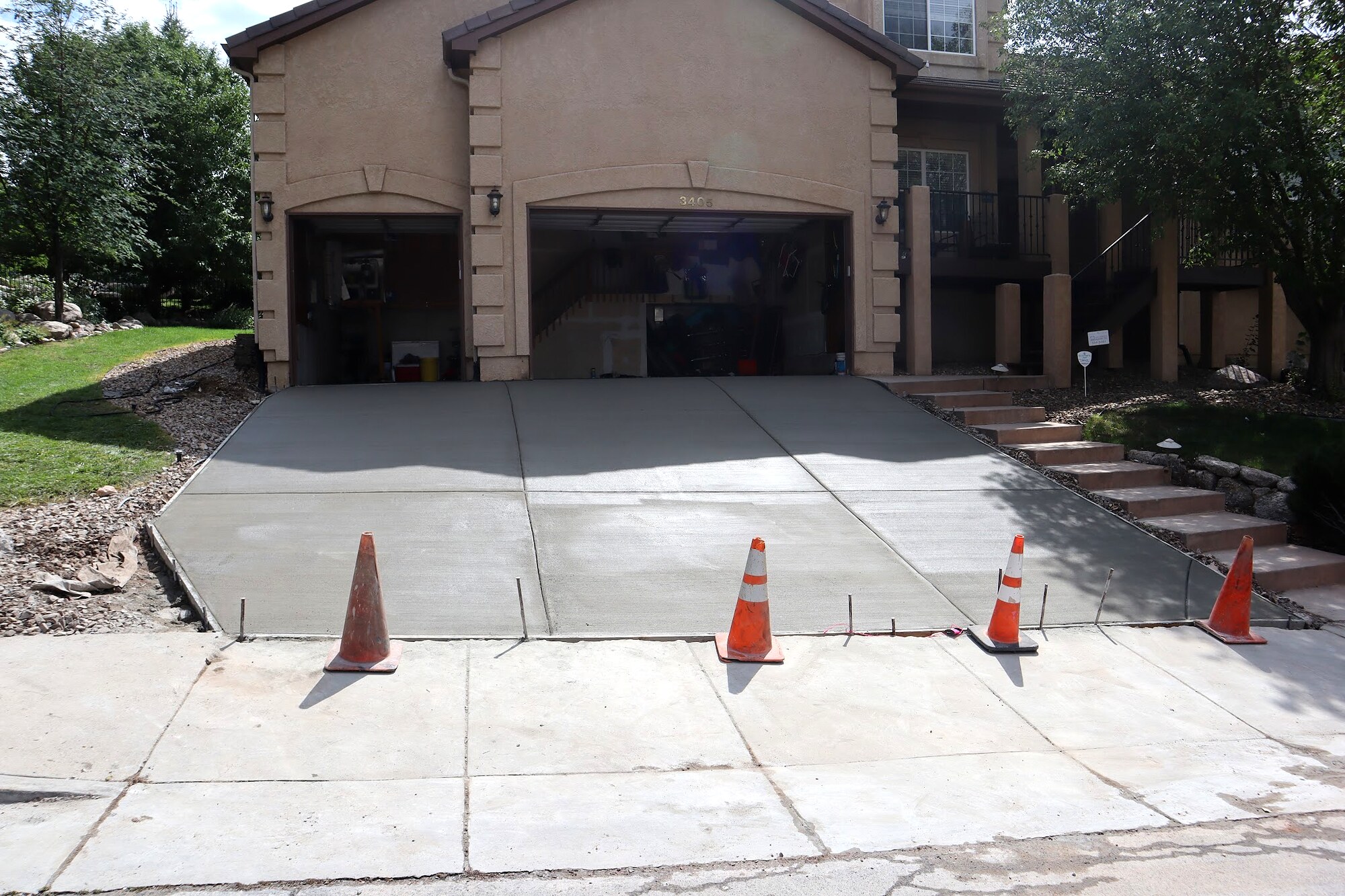 New concrete driveway replacement at a masonry home in Colorado Springs.