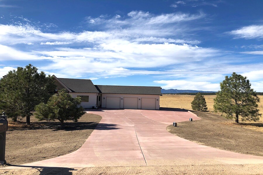 Large colored concrete driveway at a rural estate near Colorado Springs.