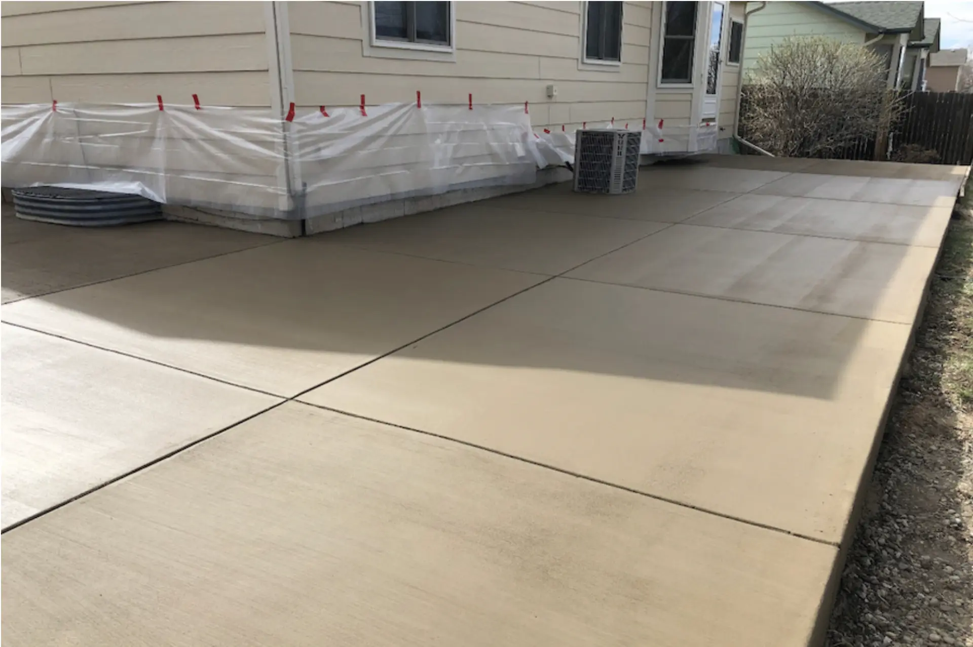 Reinforced concrete RV and trailer parking pad beside a Colorado home