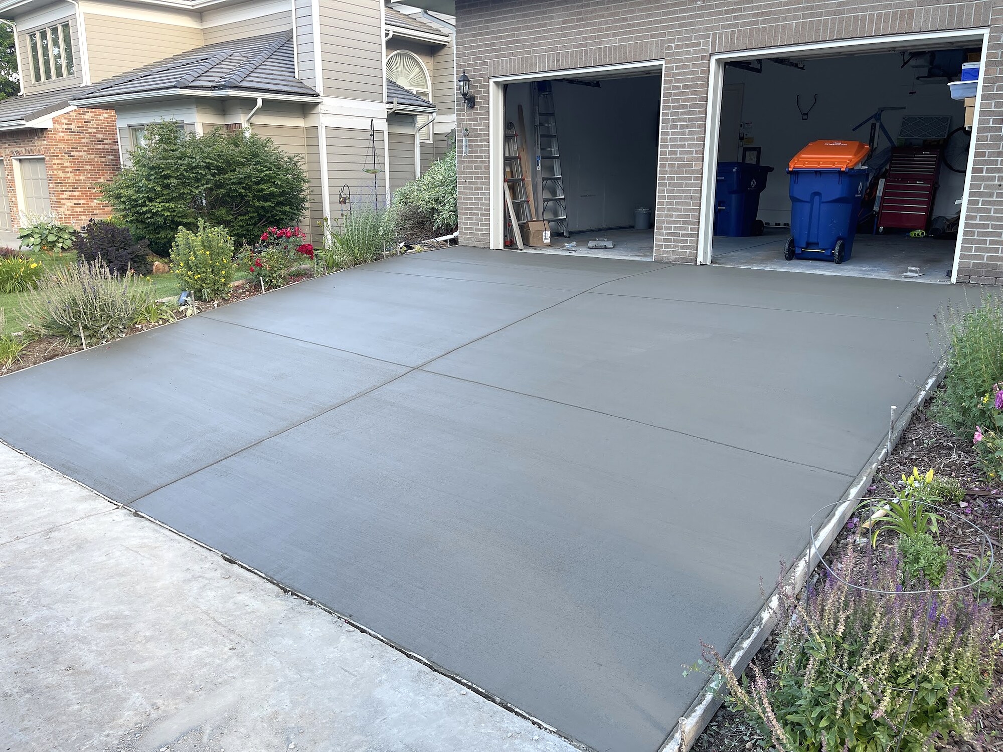Dark gray new concrete driveway at a suburban home in Colorado Springs.