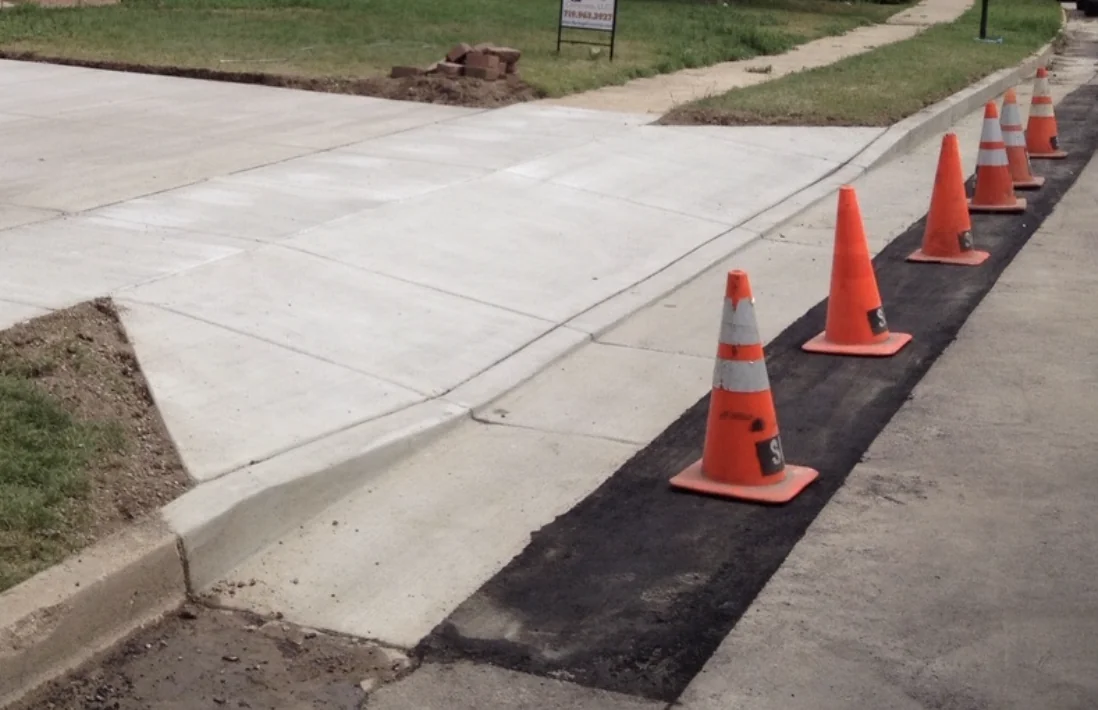 Concrete driveway apron and curb transition at a Colorado residential street