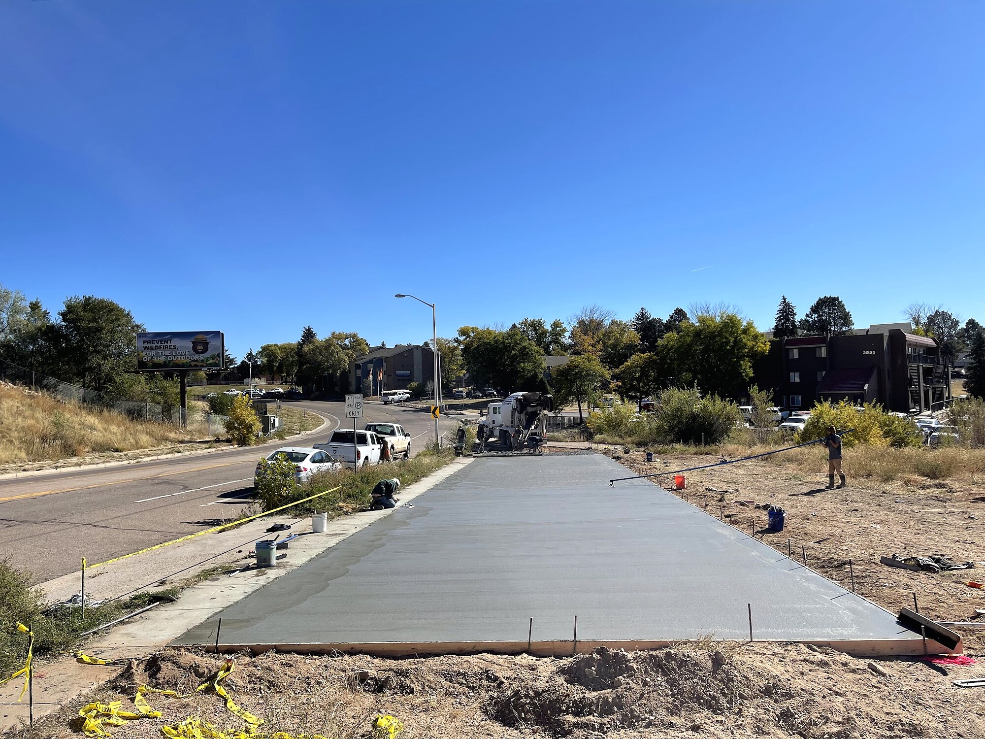 Freshly poured broad concrete driveway and street apron in Colorado Springs.