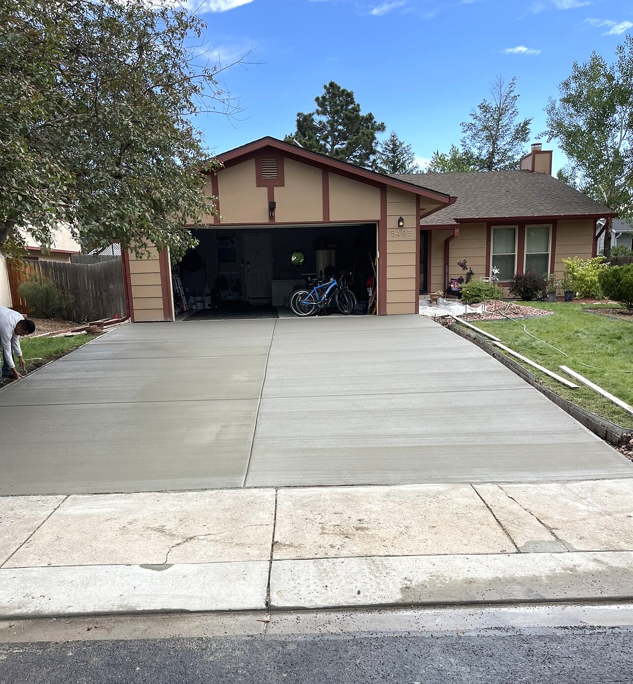 Fresh concrete driveway leading to a detached garage in Colorado Springs.